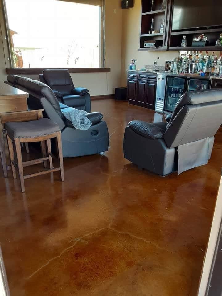 Warm brown stained concrete floor running through a furnished living space.